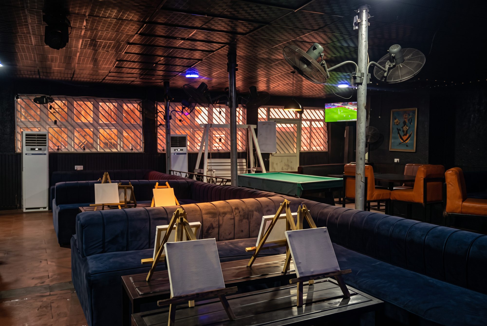Hotspot Café lounge seating and pool table at night